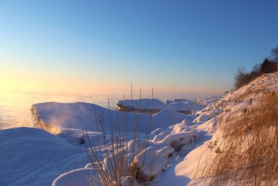 Scenic view of snowcapped mountains against clear sky during winter