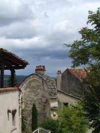 Houses against cloudy sky