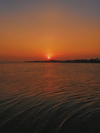 Scenic view of sea against romantic sky at sunset