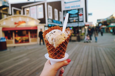 Hand holding ice cream cone