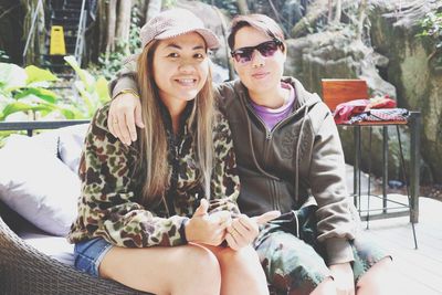 Portrait of friends sitting outdoors