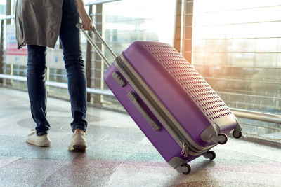 Low section of man walking at airport