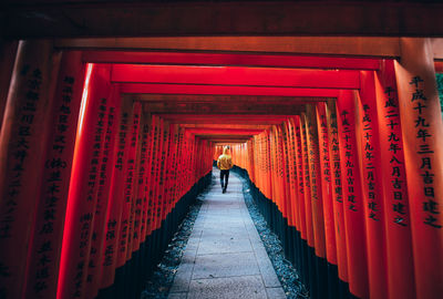 Rear view of man walking in red building