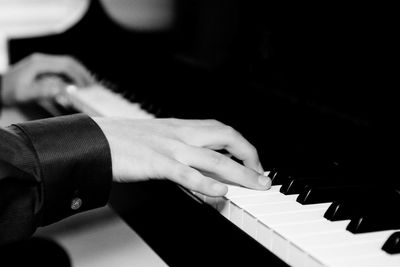 Cropped image of man playing piano