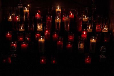 Close-up of illuminated candles in temple at night