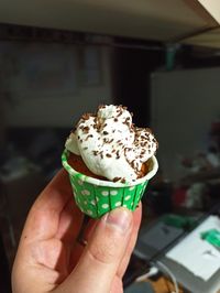 Close-up of hand holding ice cream