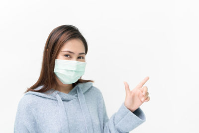 Portrait of woman wearing hat against white background