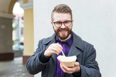 Portrait of a young man drinking glasses