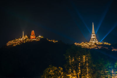 Low angle view of illuminated building against sky at night