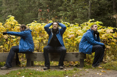 Multiple image of man sitting on wooden bench at banff national park