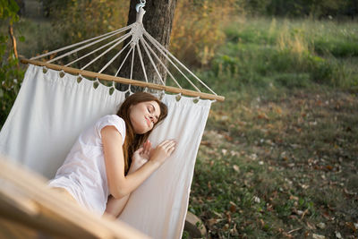 Woman sitting on hammock