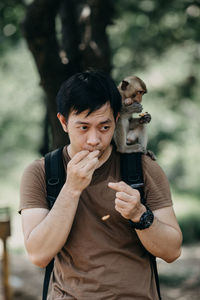 Man with monkey sitting on shoulder 
