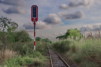 Railroad tracks by trees against sky