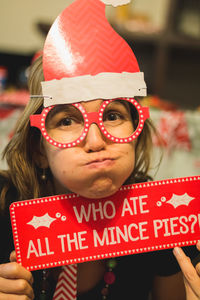 Close-up portrait of woman wearing artificial eyeglass during christmas