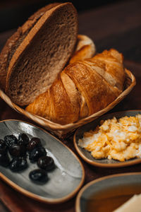 Traditional turkish breakfast with fried egg, black olives, croissant, bread, cheese, butter, honey, 