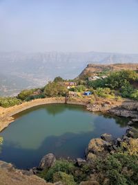 Scenic view of lake and mountains against sky