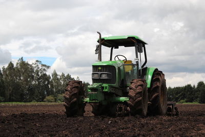 Tractor on field against sky