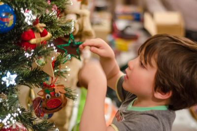 Close-up of boy holding christmas tree