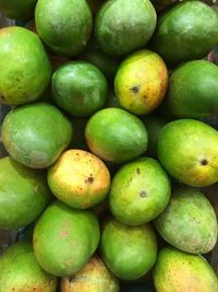 Full frame shot of unripe mangoes for sale at market