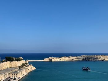 High angle view of sea against clear blue sky