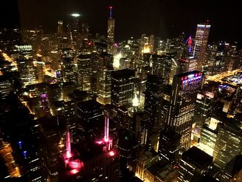 Aerial view of city lit up at night