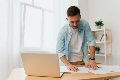 Young man using laptop at home