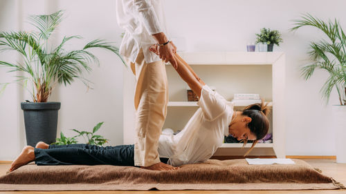 Therapist stretching womans back. shiatsu massage.