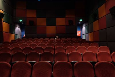 Woman sitting on chair in movie theater