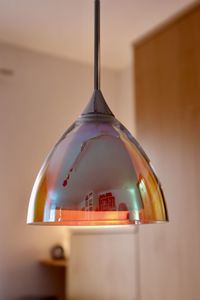 Low angle view of illuminated pendant lights hanging from ceiling