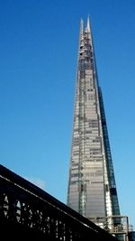 Low angle view of tower against blue sky