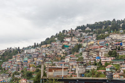 Buildings in town against sky