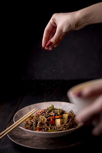 Cropped hand of person preparing food