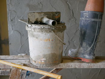 Low section of construction worker standing against wall