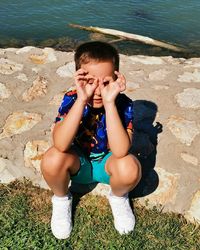 High angle view of boy sitting in water