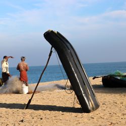 People on beach against sky