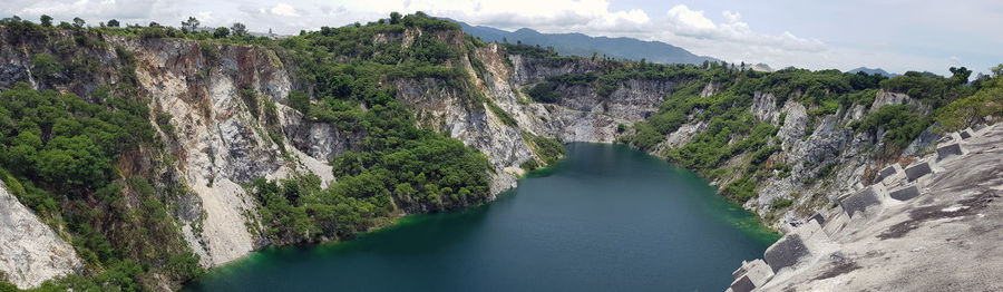 Panoramic view of river amidst mountains against sky