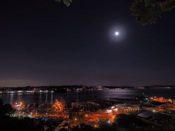 High angle view of illuminated cityscape against sky at night