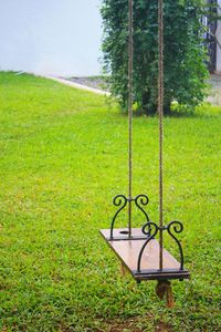 Close-up of chain swing hanging on field