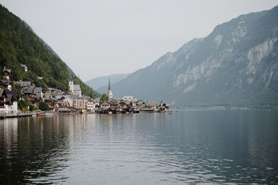 Town by sea against sky