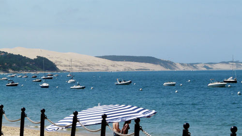 Scenic view of boats in sea against clear sky