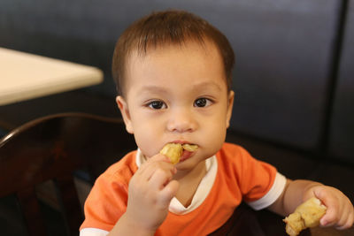 Portrait of cute boy eating food