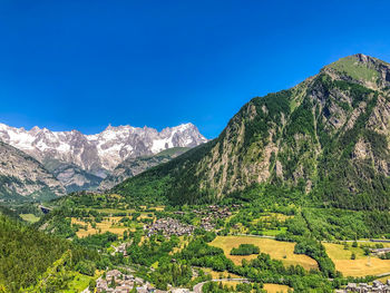 Scenic view of mountains against clear blue sky