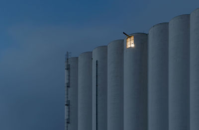 Low angle view of factory against sky during night