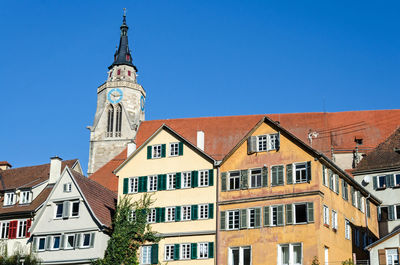 Low angle view of buildings in town against blue sky