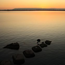 Scenic view of sea against sky at sunset