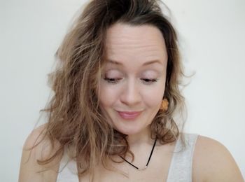 Portrait of a smiling young woman over white background