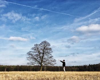 Scenic view of field against cloudy sky
