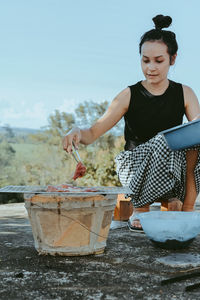 Portrait of young woman standing in boat