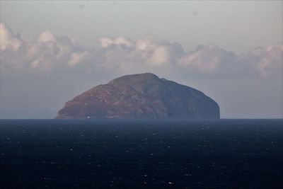 Scenic view of sea and mountains against sky