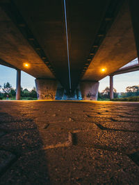 Illuminated bridge over river against sky at night